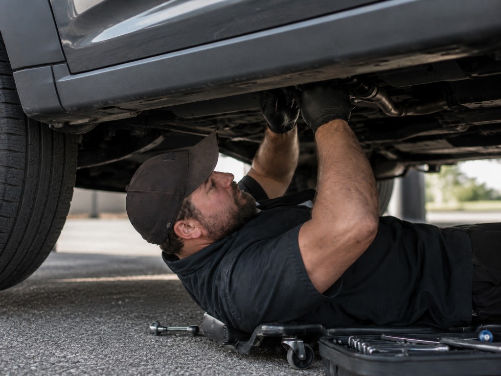 Let's Wrench mobile mechanic working underneath a vehicle on-site in the Omaha area